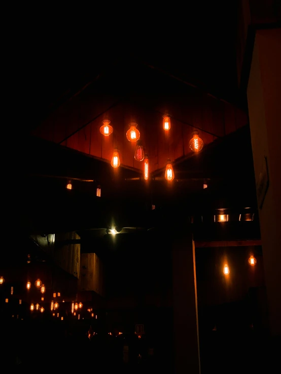 a ceiling with lanterns and lights inside at night