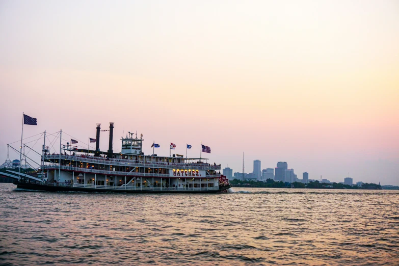 a large paddle boat is in the water at sunrise