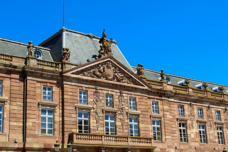 a large brick building is shown under a blue sky