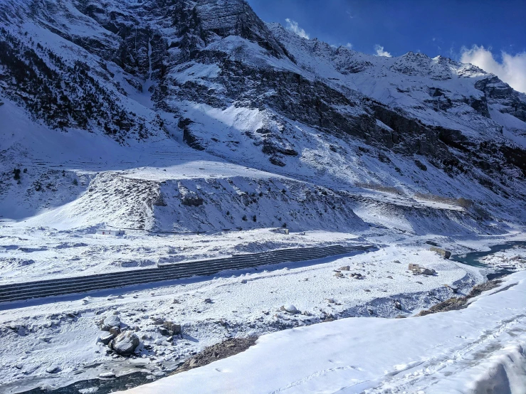 a person on skis stands in front of a snowy mountain