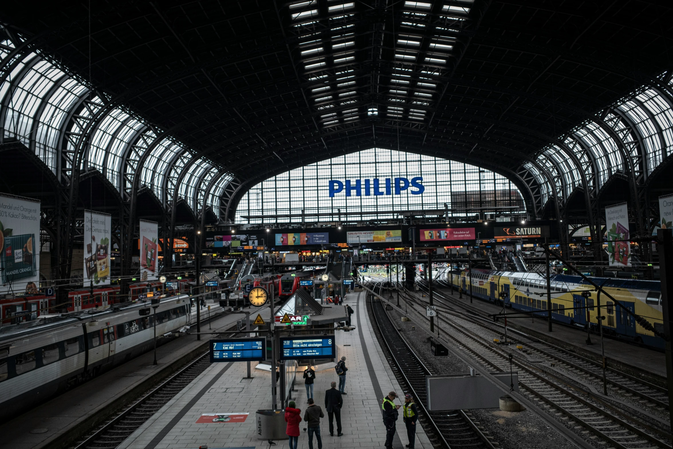 an overhead train station with people on the platform