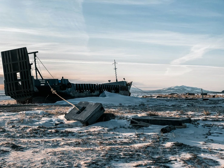 the ship is being sunk on the sand near the water