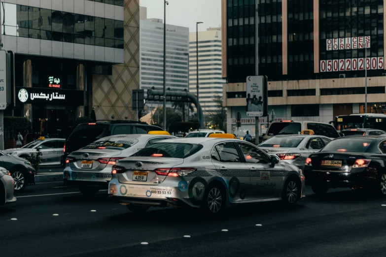 a bunch of cars that are driving down the road