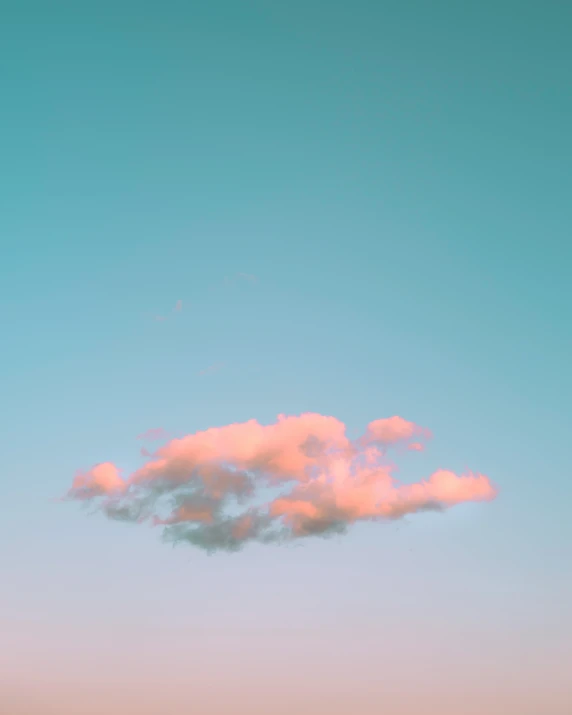 a plane flies through the air behind some pink clouds