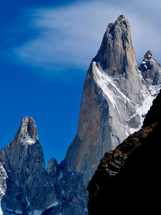 the view of several tall mountain peaks from below