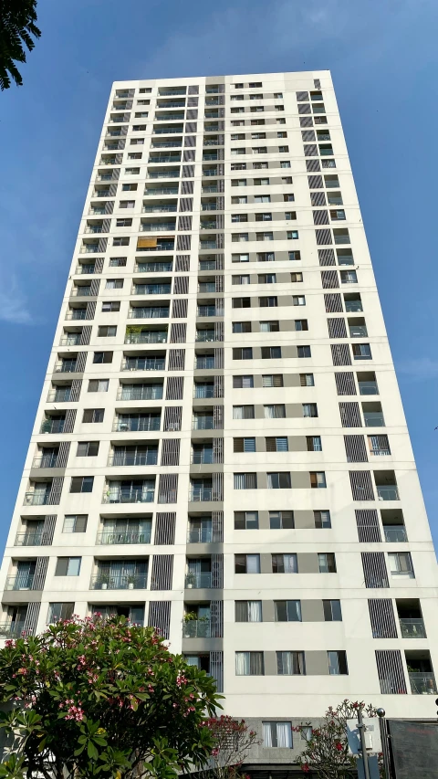 a tall apartment building against a blue sky