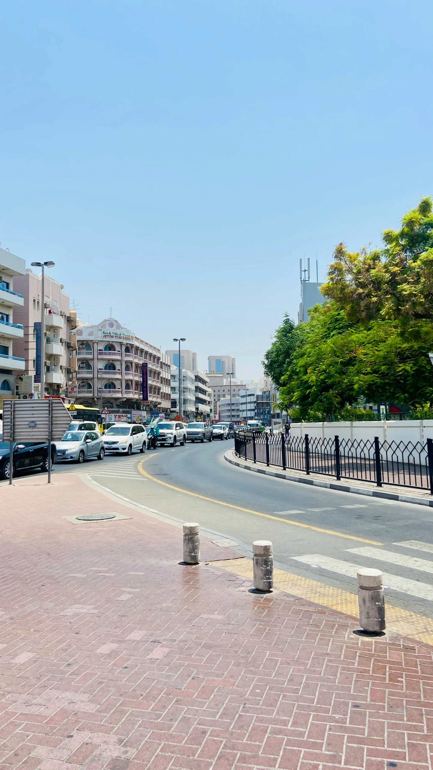 people walking on the sidewalk of the empty street