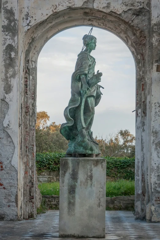 a statue is shown in a large area with brick arches