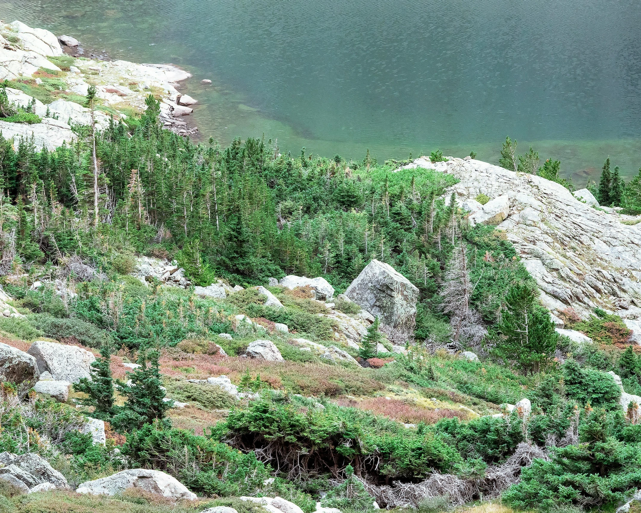 a view from a hill over the water