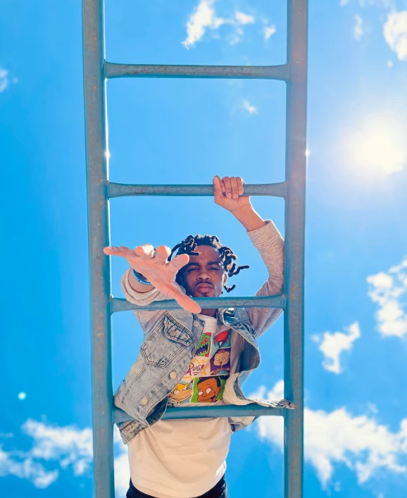 a person on top of a ladder reaching for the sky