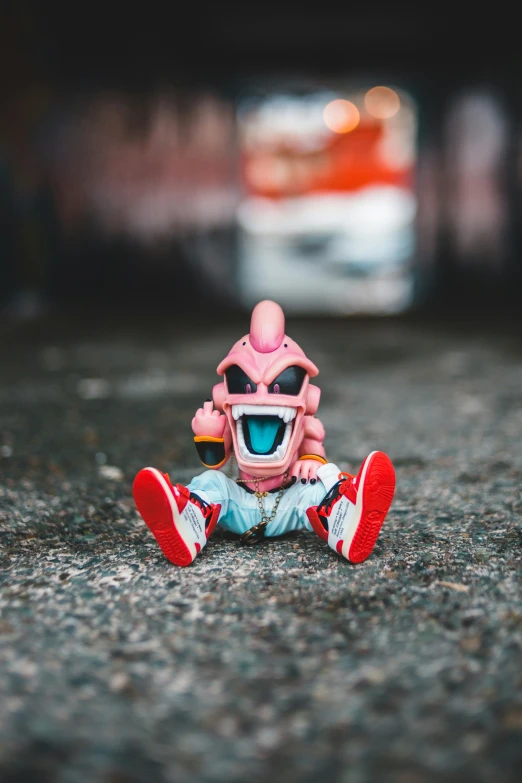 a toy doll with a pink mask sitting on a road