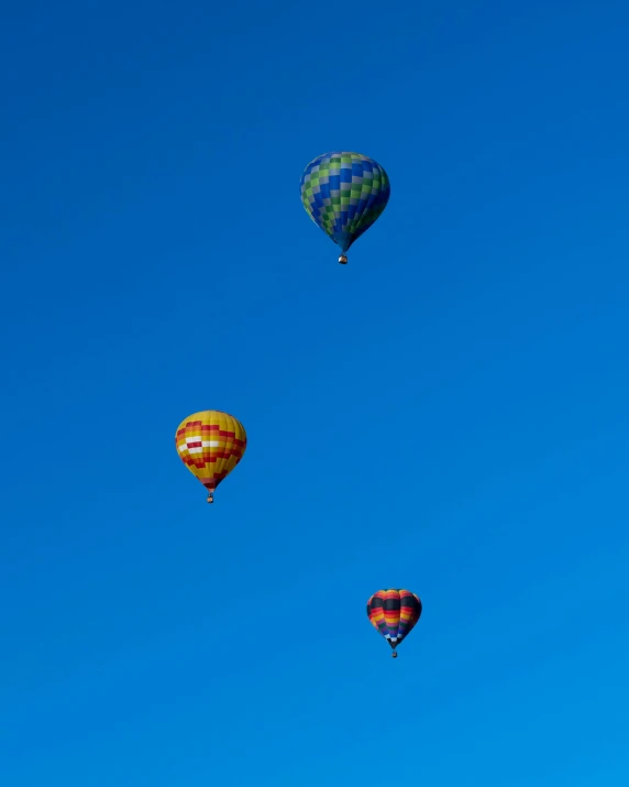 four  air balloons in the sky ascend up