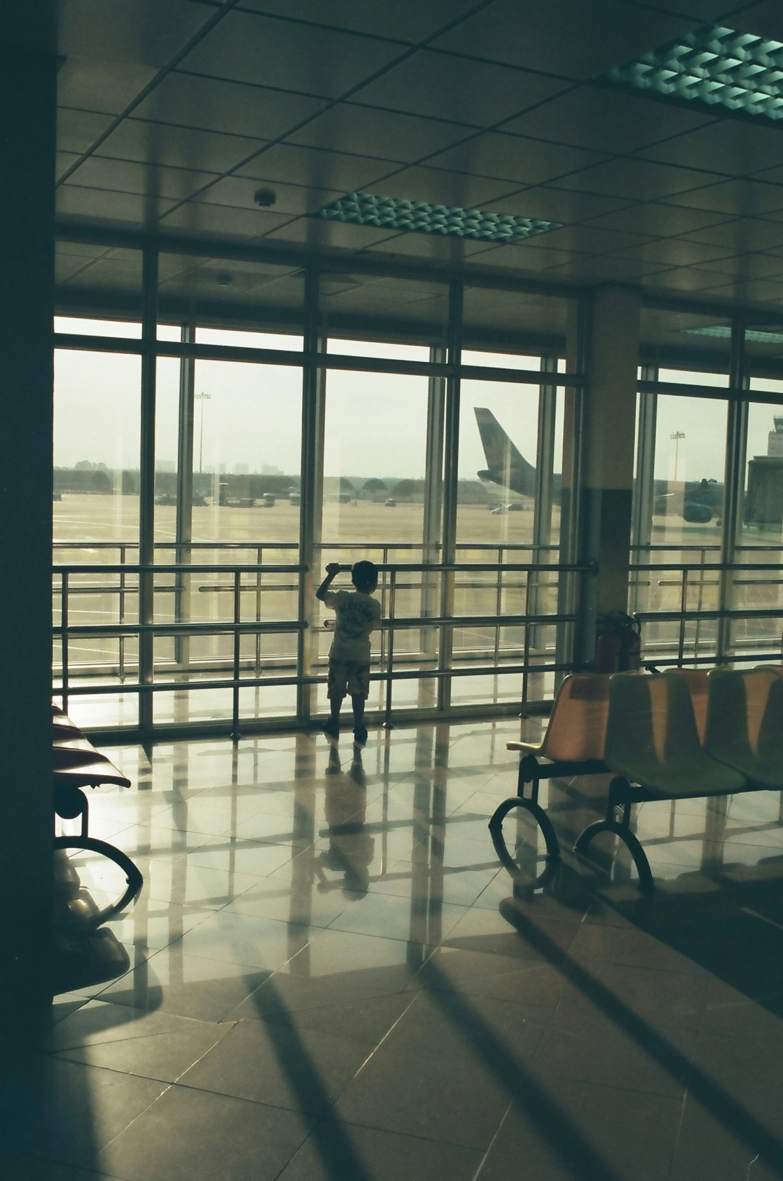 a person stands in front of a luggage cart at an airport