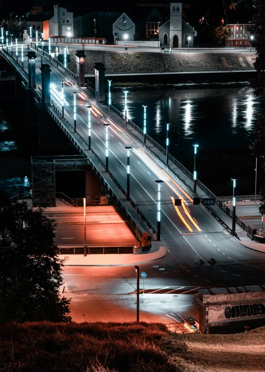 night time view of a city and river with light trails