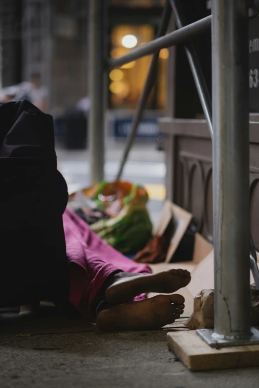 someone laying on the sidewalk next to their food