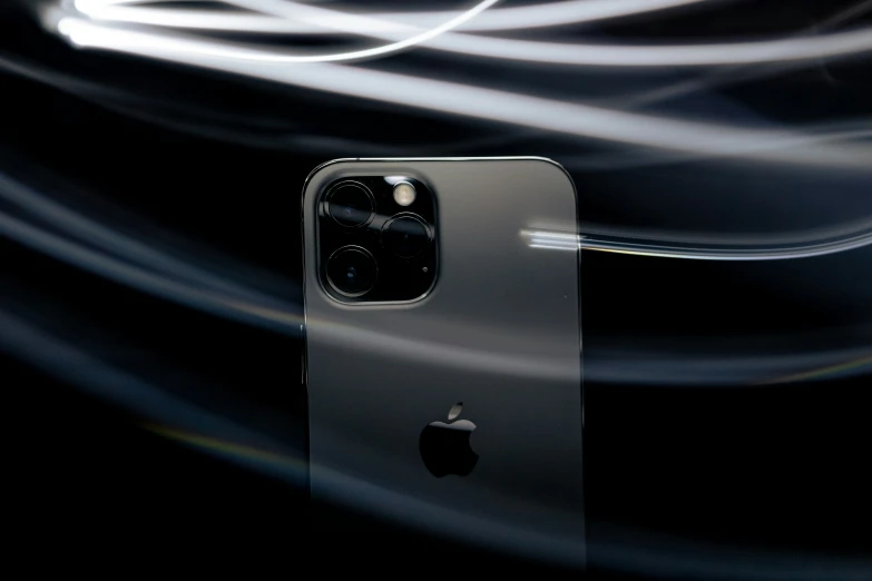 an apple phone with its camera facing slightly towards the camera