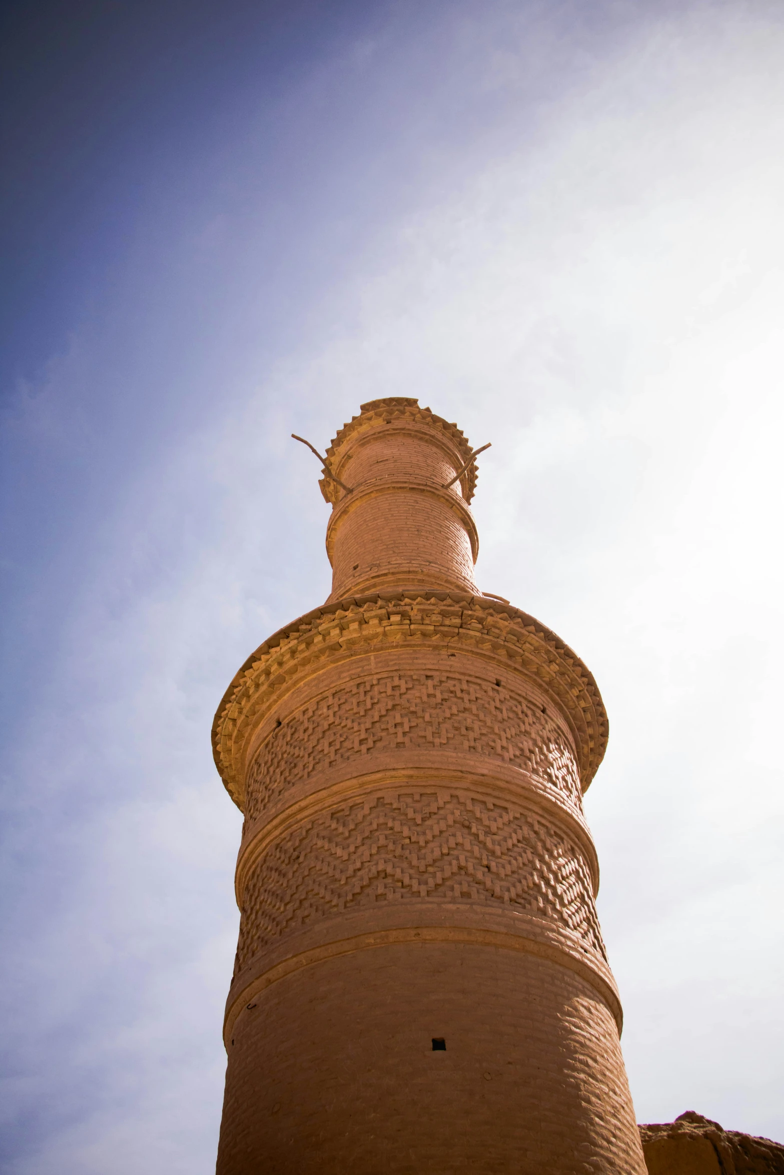 a tower in the middle of a blue sky