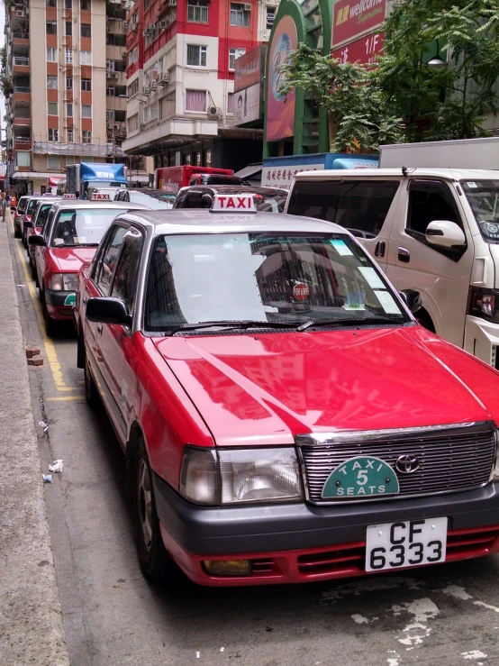 a red car is parked on a street