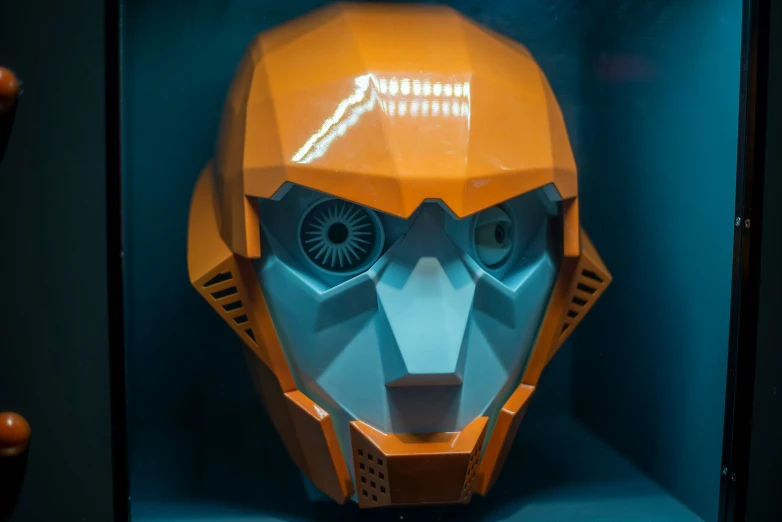 an orange mask with a hole in the face