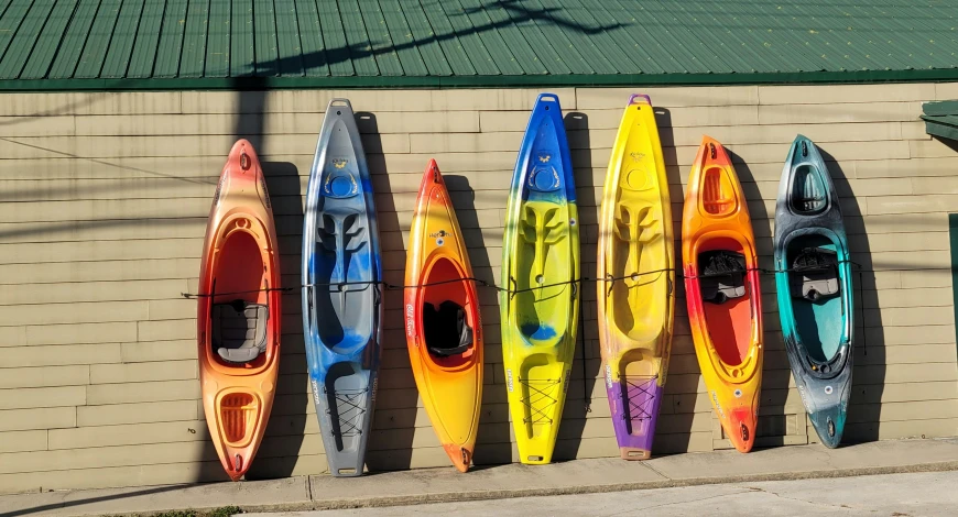several kayaks are set up outside the building