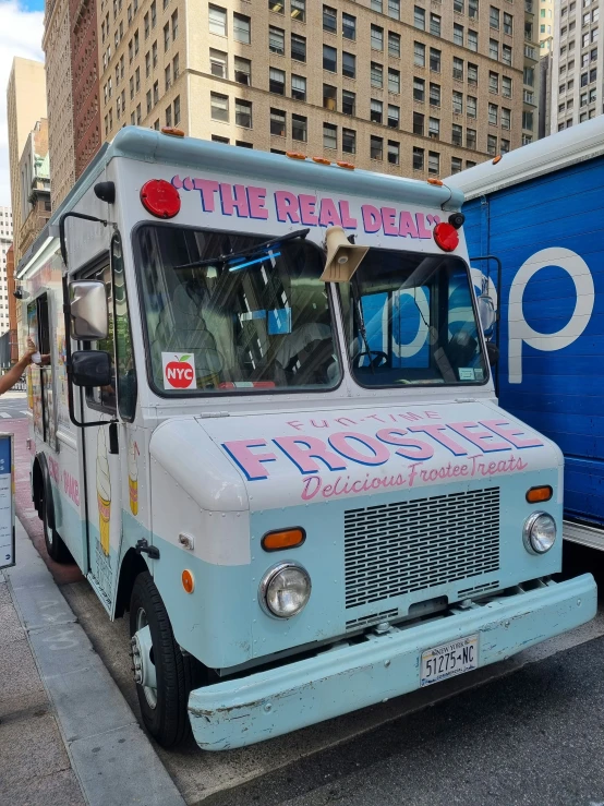 a blue truck is parked in front of a blue trailer