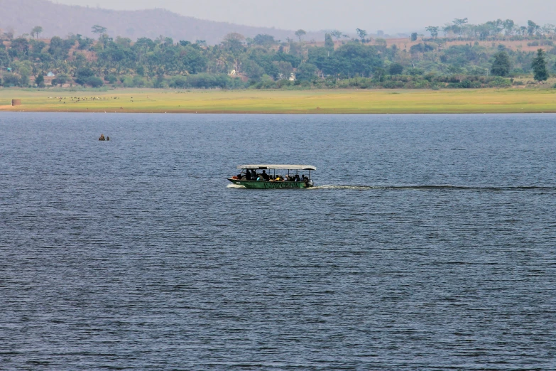 a small boat is on the water near a shore