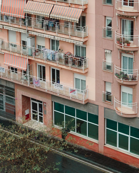 a tall pink building with balconies and balconyes