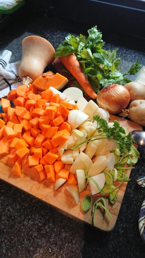 cut up carrots, onions and celery on a  board