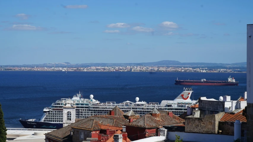 cruise ship in the distance near a harbor