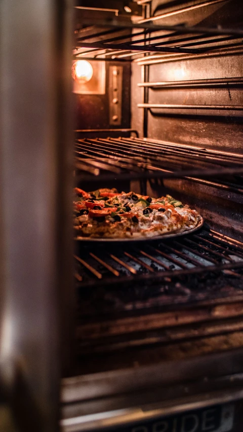 the pizza is being cooked inside the oven