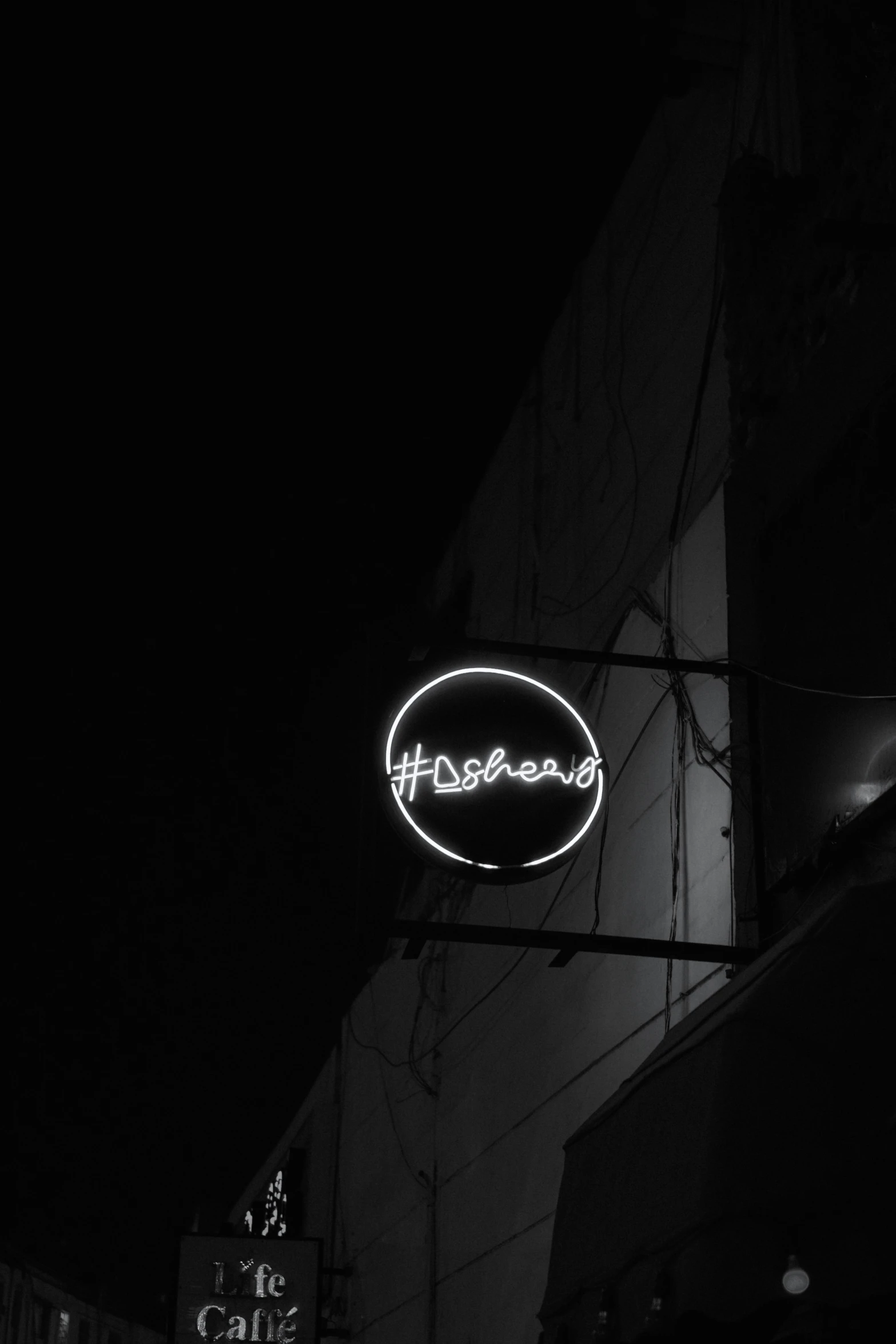 this is a business sign at night on the side of a building