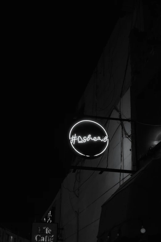 this is a business sign at night on the side of a building