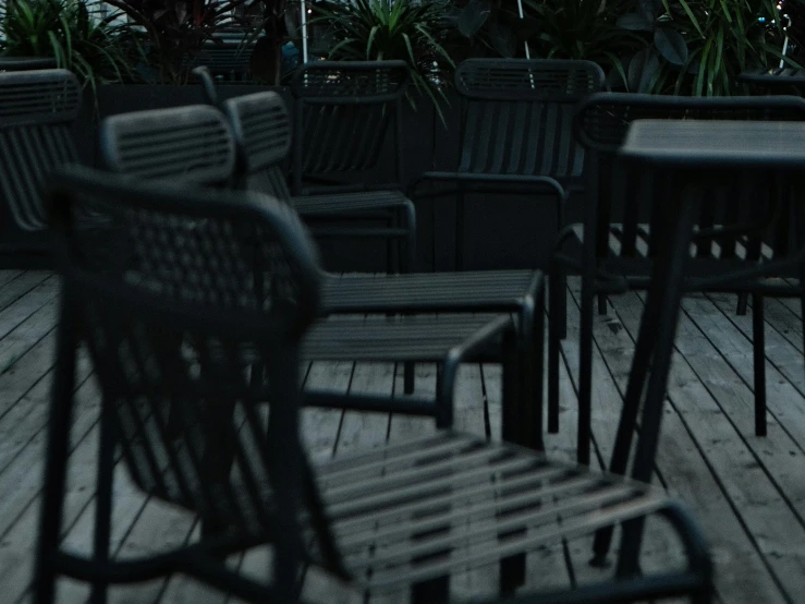 an assortment of chairs and tables on the outside deck