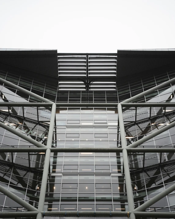 a tall building with several windows and multiple silver metal rails