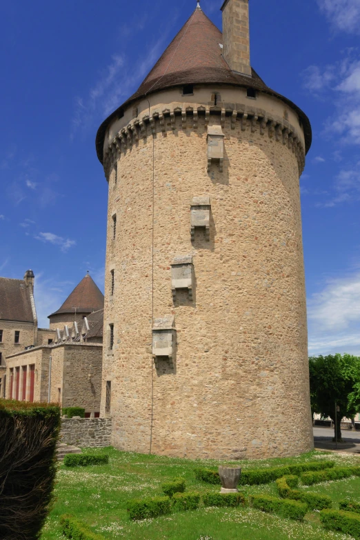 a castle like building sits on top of some grass