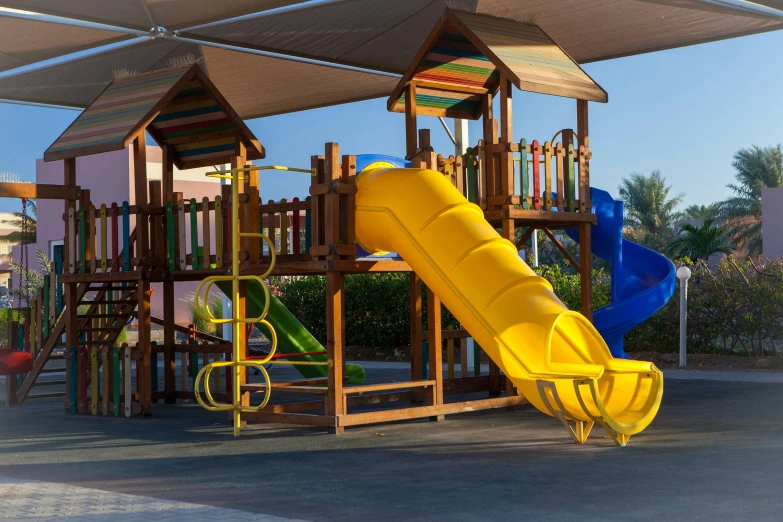 an outdoor playground structure with a yellow slide