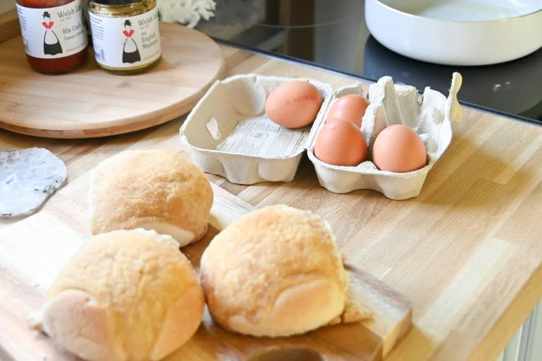 eggs and buns on a  board with spoon