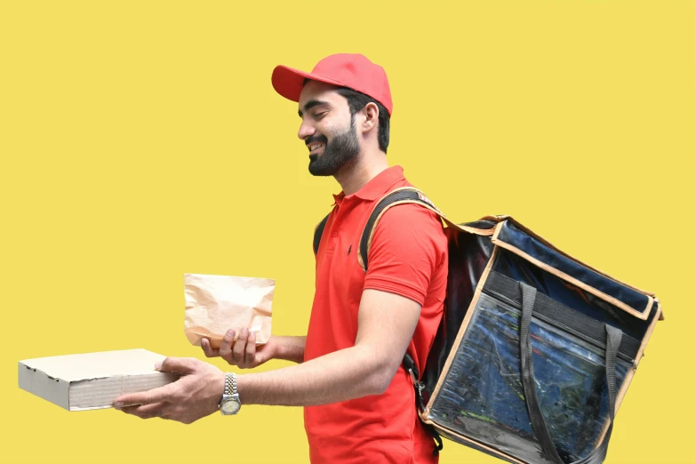 a man is carrying a box and backpack