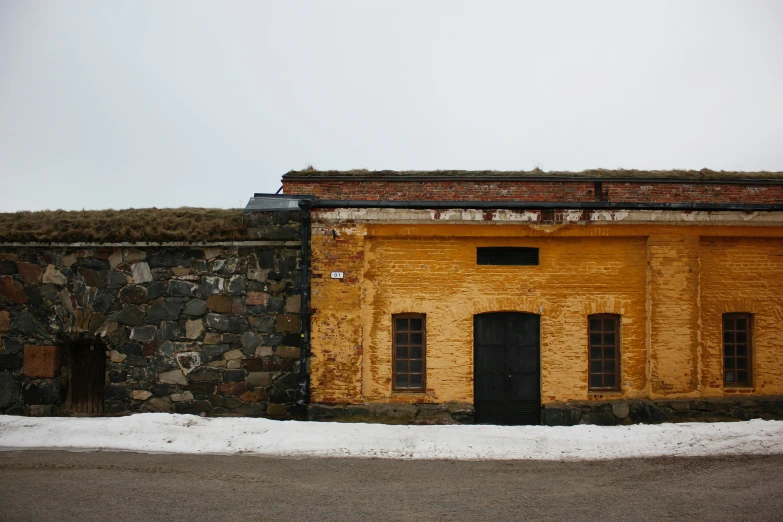 there is a building with a stone wall and roof