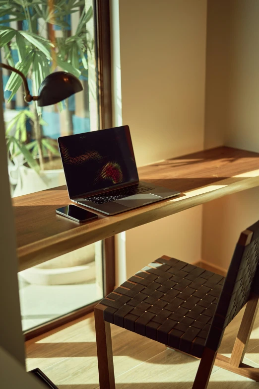 there is an open laptop that sits on a desk