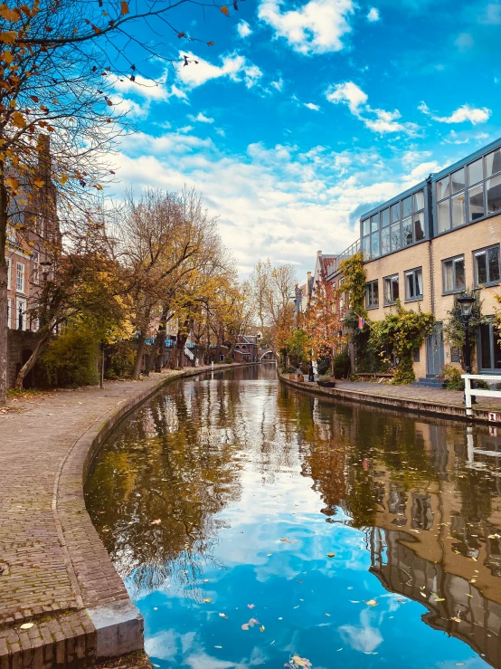 beautiful autumn scene with clouds reflecting in the water