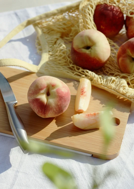 apples are shown on the  board with a knife
