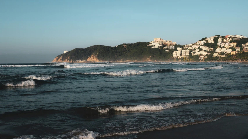 waves on the beach and on top of houses