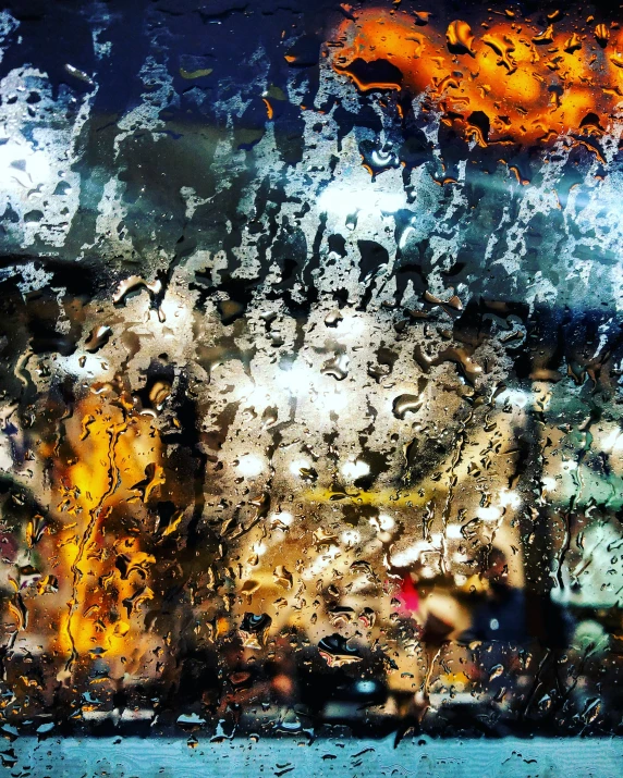 view from inside of an outdoor rain - soaked window to the sky