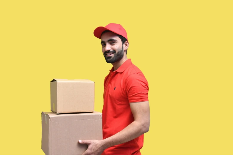a man in a red cap is holding two boxes