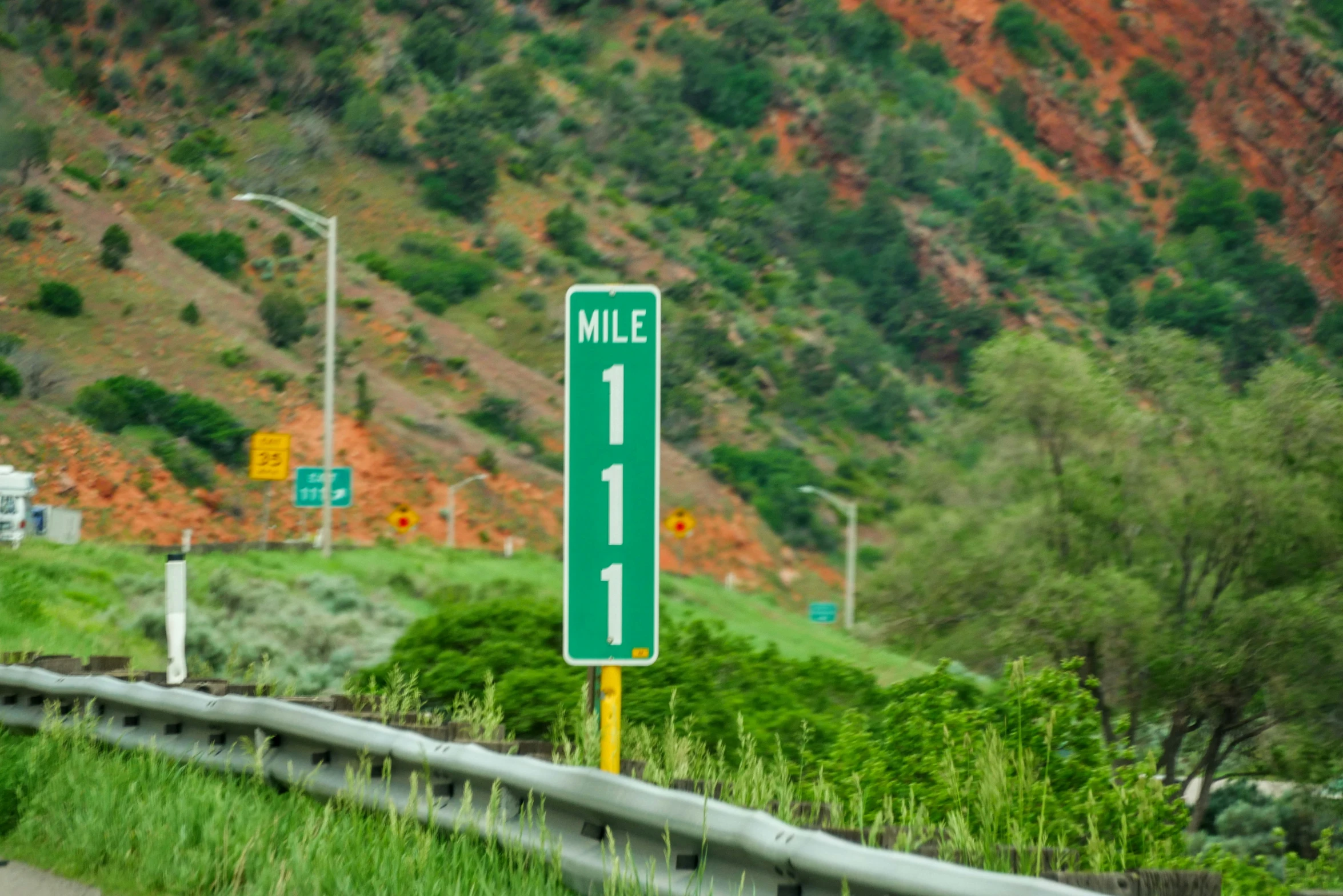 a road with a mile sign on the side