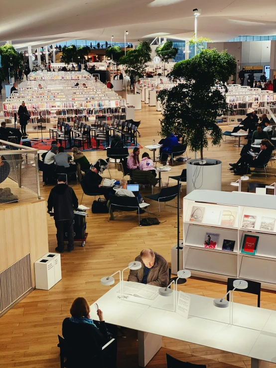 many people sitting at various tables in a large room