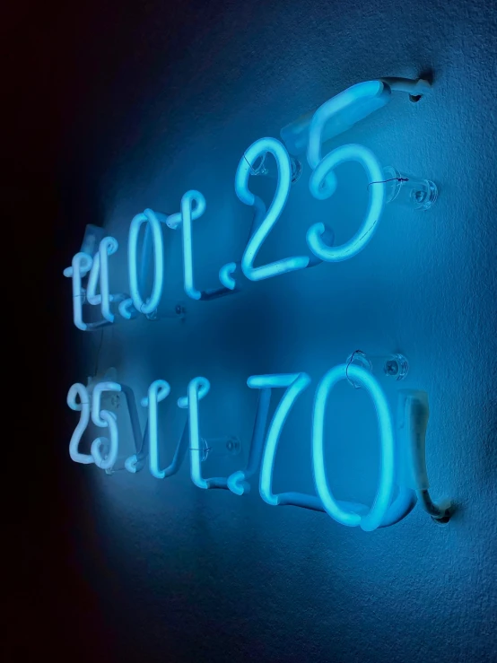 a neon sign reads pizzles twenty five minutes per hour