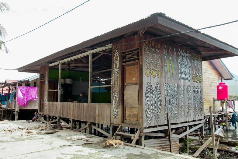 a small hut is standing in a flooded area