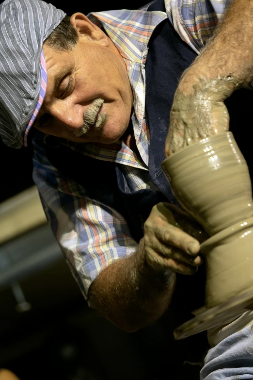 a man is making pottery on a potter's wheel